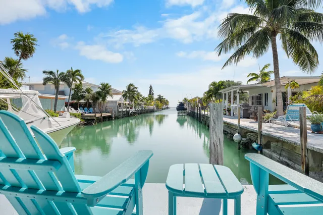 a front view of a house with a yard and potted plants