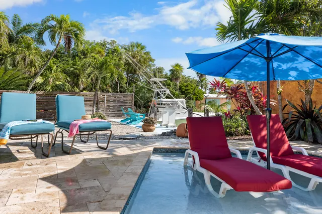 an aerial view of a house with a lake and garden