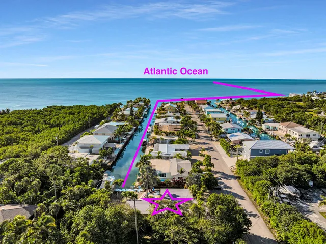 a kitchen with stainless steel appliances granite countertop sink stove refrigerator and cabinets