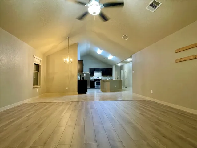 a view of kitchen with cabinets appliances and wooden floor