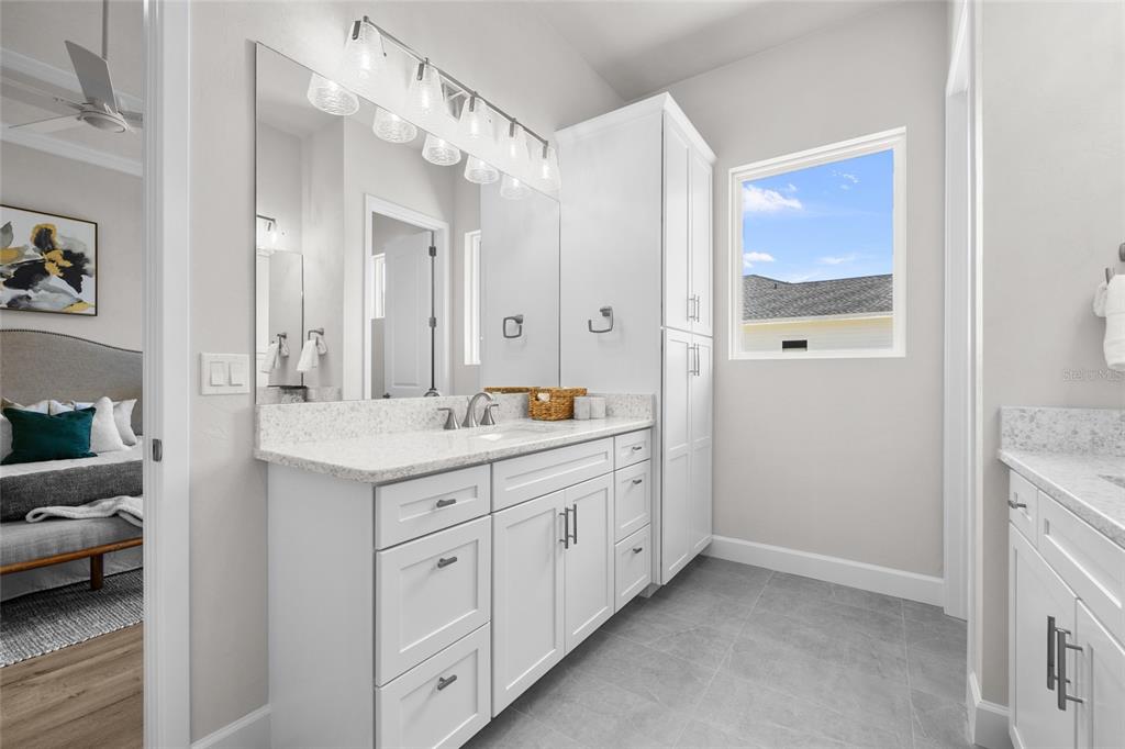 13425 Southwest 9th Road Newberry, FL 32669 - Photo 25 of 37 a spacious bathroom with a granite countertop sink a mirror and a