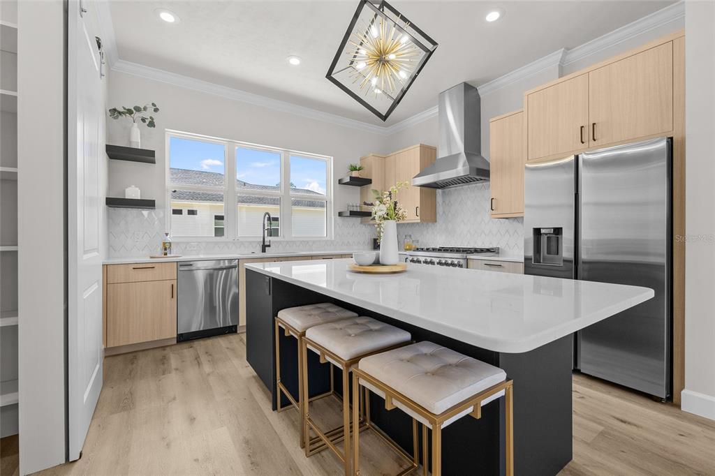 13425 Southwest 9th Road Newberry, FL 32669 - Photo 4 of 37 a kitchen with kitchen island a sink stove and refrigerator
