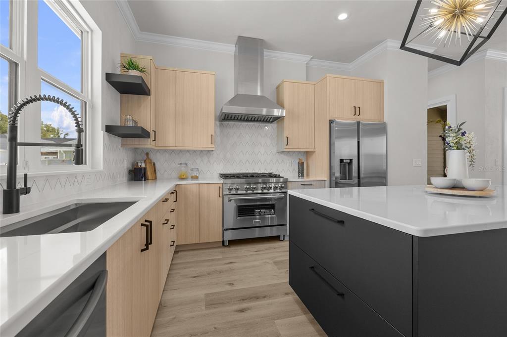 13425 Southwest 9th Road Newberry, FL 32669 - Photo 5 of 37 a kitchen with stainless steel appliances a sink stove and cabinets