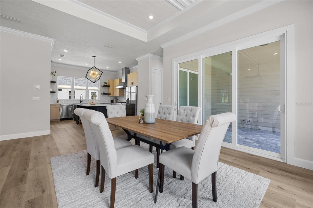13425 Southwest 9th Road Newberry, FL 32669 - Photo 9 of 37 a view of a dining room with furniture and wooden floor