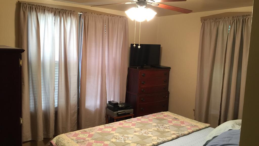 111 North Main Street Springfield, TN 37172 - Photo 13 of 25 a bedroom with a bed and a chandelier