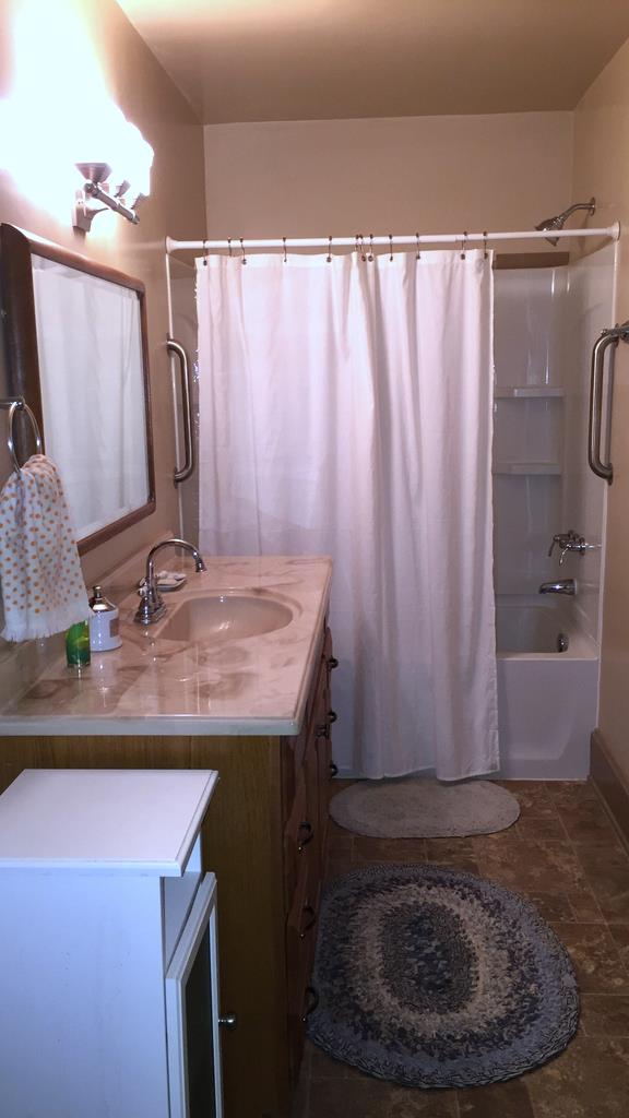 111 North Main Street Springfield, TN 37172 - Photo 15 of 25 a bathroom with a granite countertop sink and a mirror