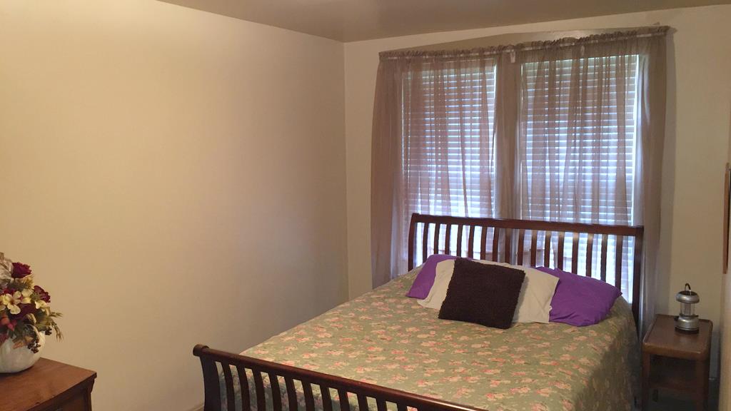 111 North Main Street Springfield, TN 37172 - Photo 16 of 25 a large bed sitting in a bedroom next to a window