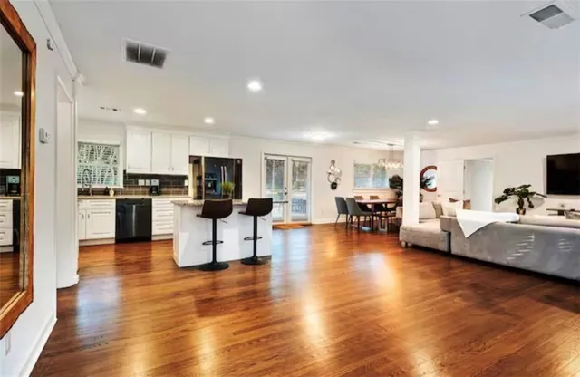 a kitchen with stainless steel appliances granite countertop a stove sink microwave and cabinets