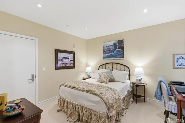 a bedroom with a bed and a table with chair