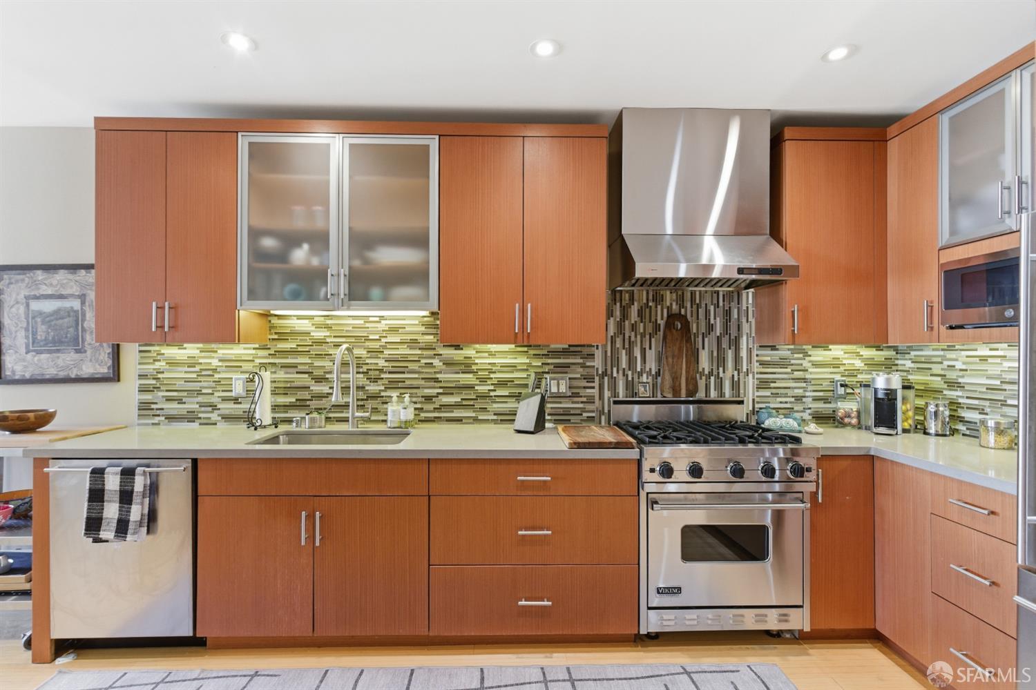 1725 Washington Street, Unit 9 San Francisco, CA 94109 - Photo 7 of 13 a kitchen with stainless steel appliances granite countertop a stove and a refrigerator