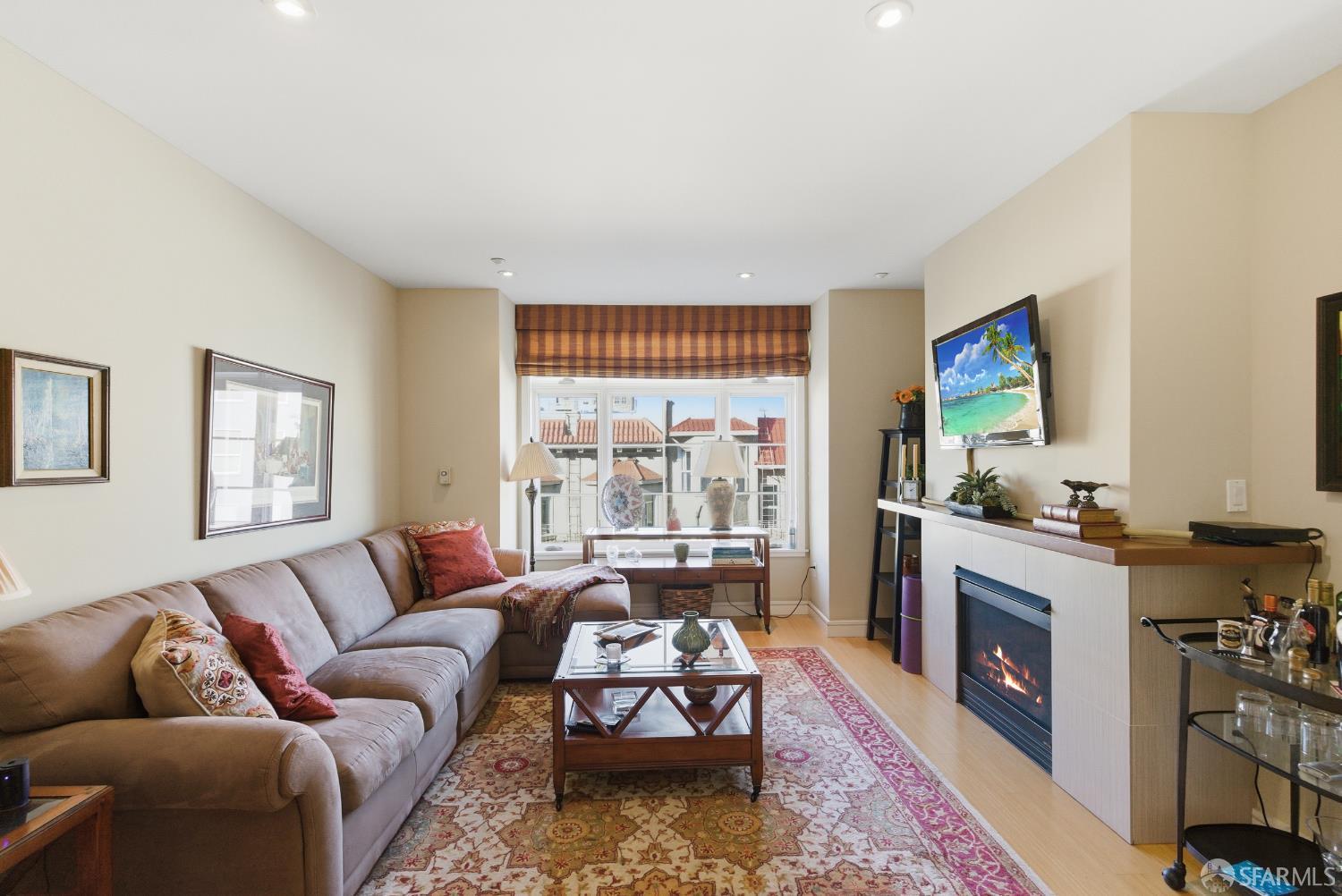 1725 Washington Street, Unit 9 San Francisco, CA 94109 - Photo 8 of 13 a living room with furniture and a fireplace