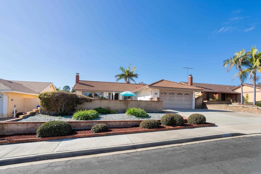 4427 Trieste Drive Carlsbad, CA 92010 - Photo 1 of 24 an aerial view of a house with a yard and potted plants