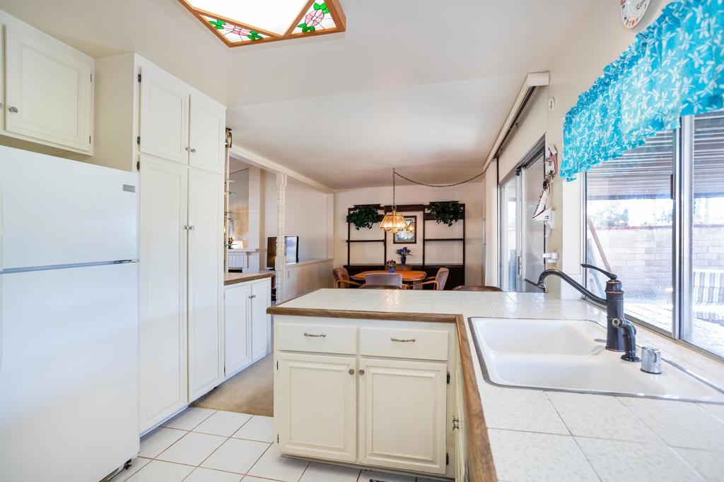 4427 Trieste Drive Carlsbad, CA 92010 - Photo 11 of 24 a kitchen with white cabinets and window