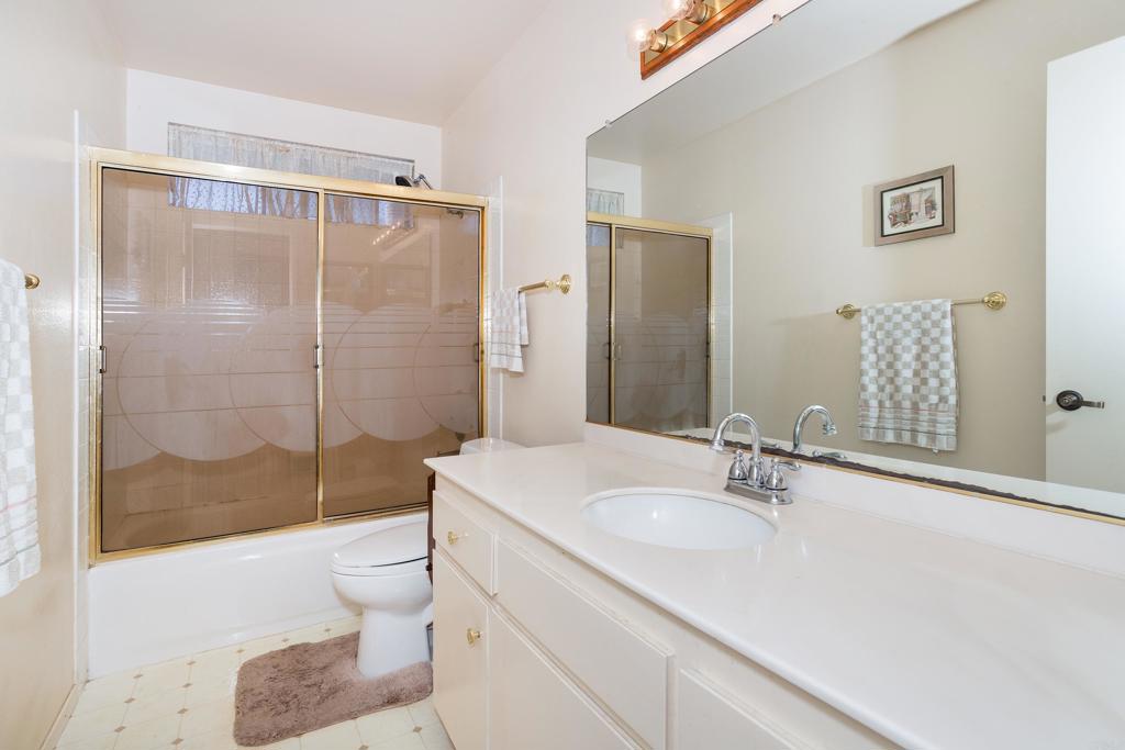 4427 Trieste Drive Carlsbad, CA 92010 - Photo 13 of 24 a bathroom with a sink toilet and shower