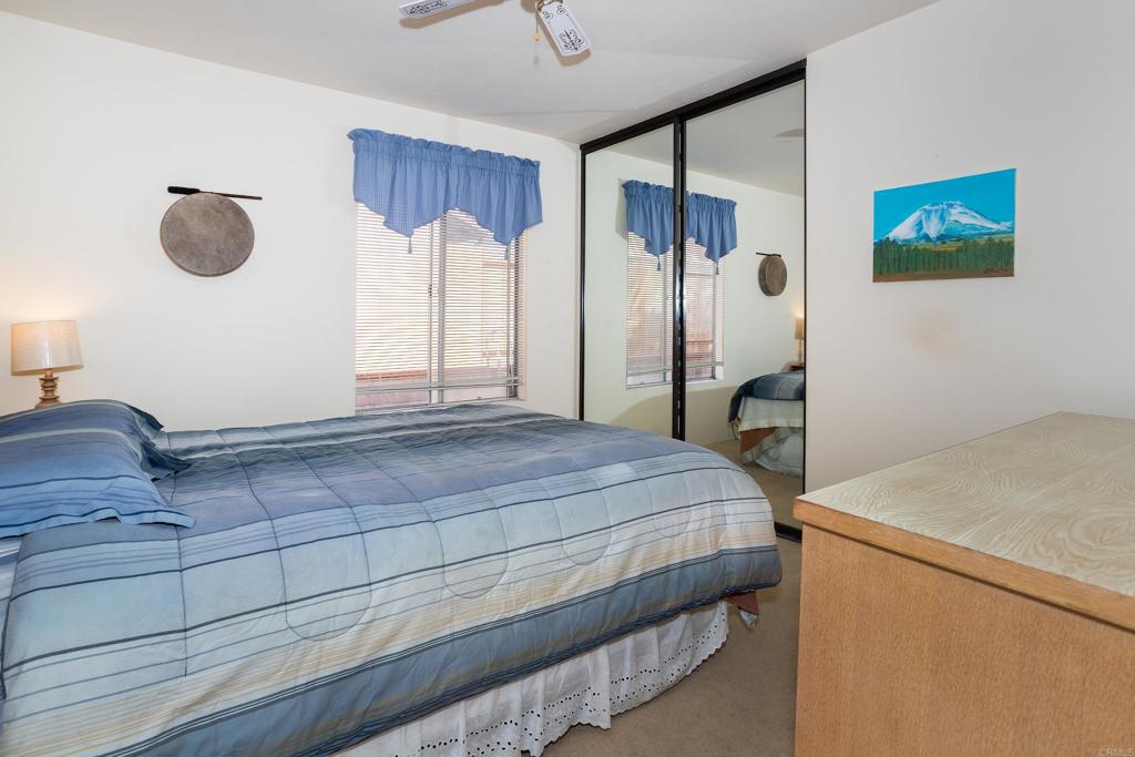 4427 Trieste Drive Carlsbad, CA 92010 - Photo 16 of 24 a bedroom with a bed and a cabinets