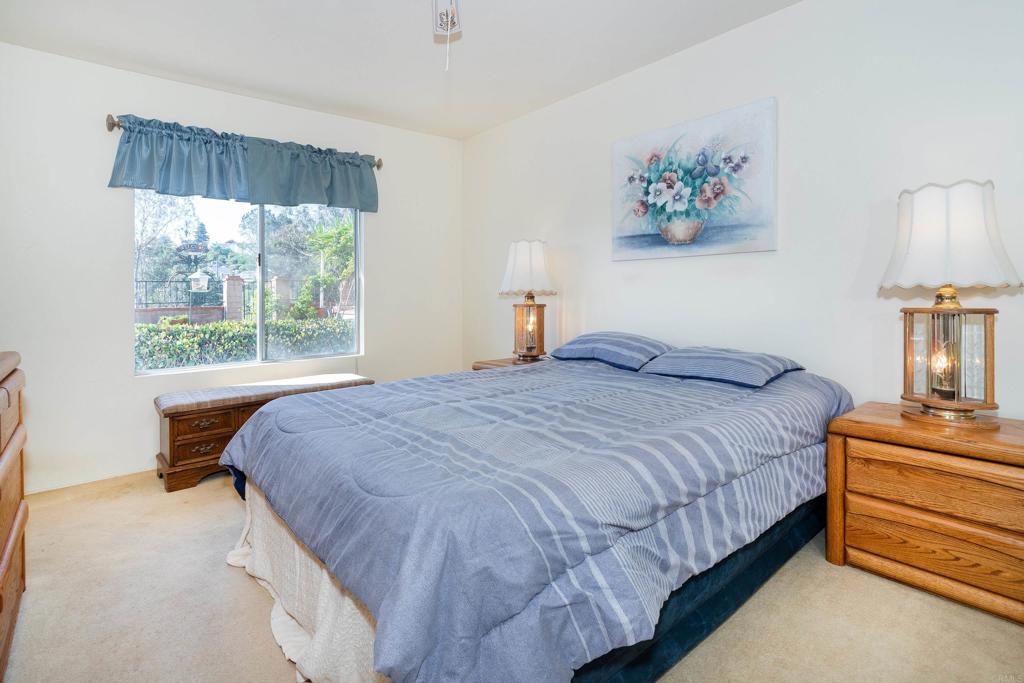 4427 Trieste Drive Carlsbad, CA 92010 - Photo 17 of 24 a bedroom with a bed and a window