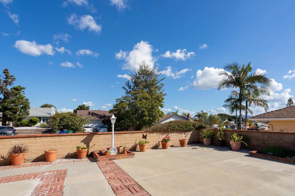 4427 Trieste Drive Carlsbad, CA 92010 - Photo 3 of 24 a view of a swimming pool with a table and chairs under an umbrella
