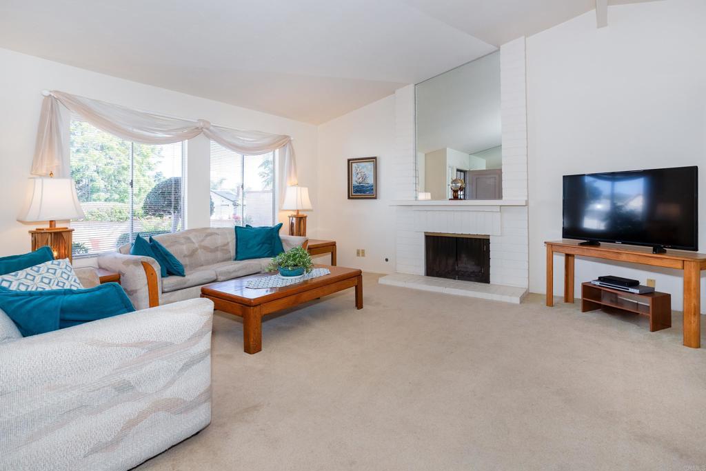 4427 Trieste Drive Carlsbad, CA 92010 - Photo 5 of 24 a living room with furniture and a flat screen tv
