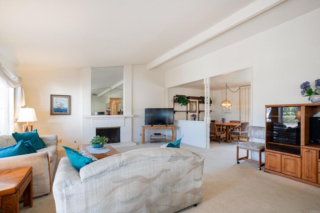 4427 Trieste Drive Carlsbad, CA 92010 - Photo 6 of 24 a living room with furniture and a flat screen tv