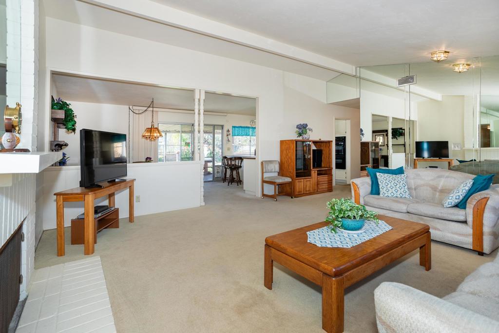 4427 Trieste Drive Carlsbad, CA 92010 - Photo 7 of 24 a living room with furniture and a flat screen tv