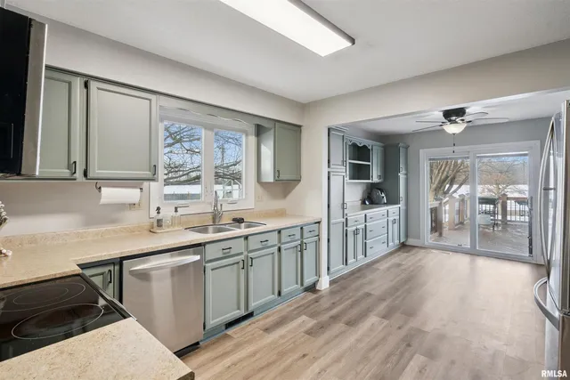 a large kitchen with a lot of counter space and a wooden floor