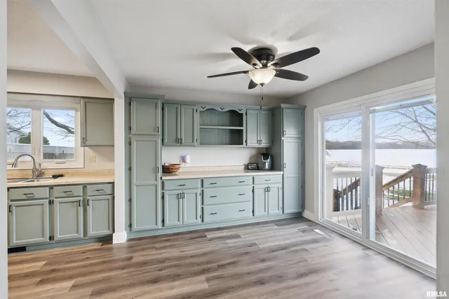 a spacious bathroom with a granite countertop sink and a large mirror