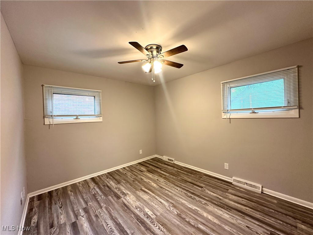4500 Green Road Cleveland, OH 44128 - Photo 8 of 13 Empty room featuring plenty of natural light, dark wood-style flooring, and ceiling fan