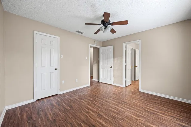 a view of an empty room and wooden floor