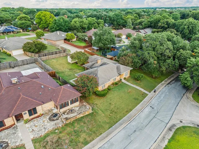 an aerial view of residential houses with outdoor space and street view