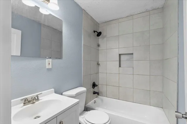 a bathroom with a sink a toilet and bathtub