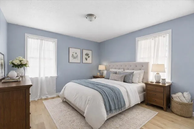 a bedroom with a bed and a potted plant