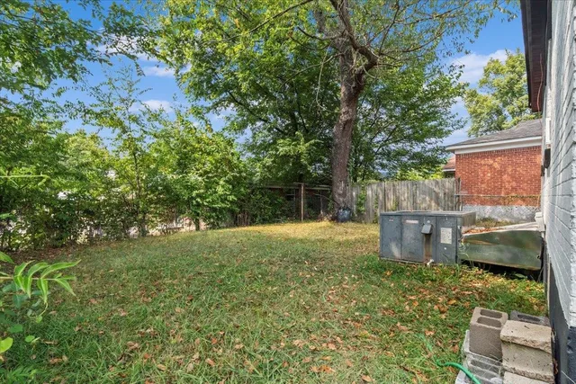 a view of a backyard with plants and a patio