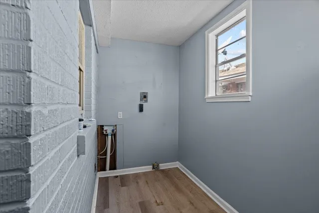 a view of a room with rack on the wall and a window