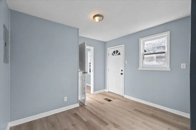 an empty room with windows and closet