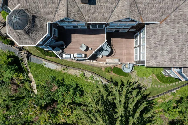 a front view of a house with balcony and garden