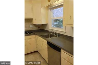 723 Nottingham Road Baltimore, MD 21229 - Photo 5 of 27 a kitchen with a sink cabinets and a window