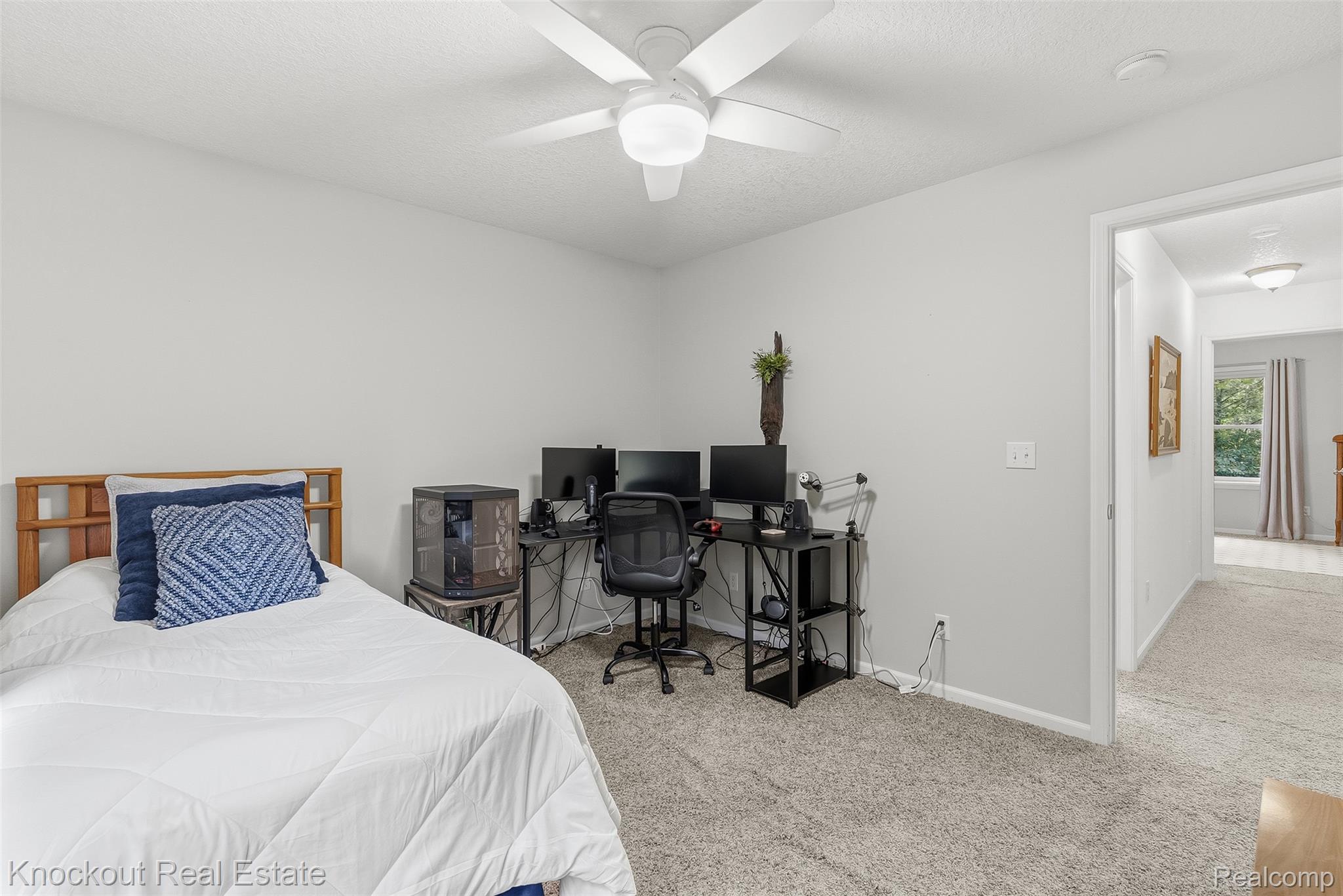 8436 Birch Run Road Millington, MI 48746 - Photo 23 of 44 Neutral-toned room featuring a ceiling fan, light gray wall paint, and gray carpet flooring