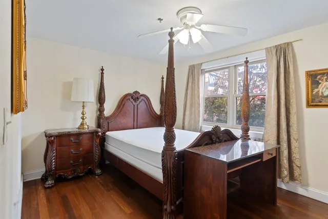 a bedroom with a bed and a large window