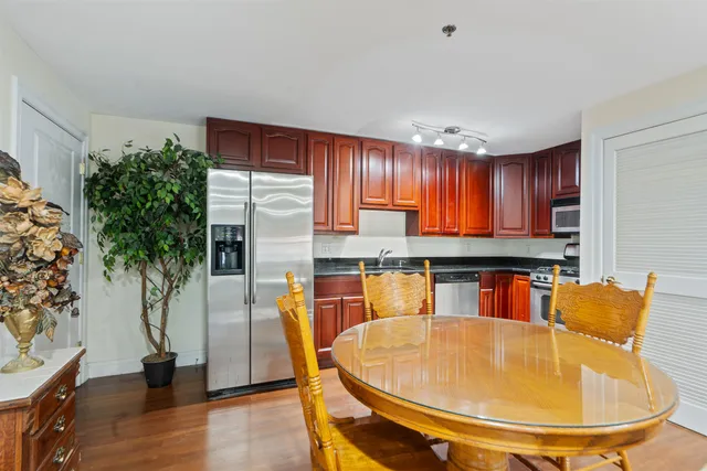 a kitchen with granite countertop cabinets stainless steel appliances and a sink