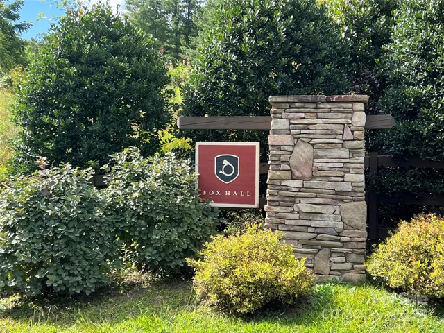 a sign that is sitting in front of flowers