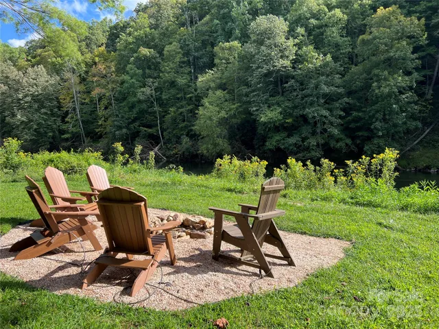 a view of a backyard with chairs and a garden
