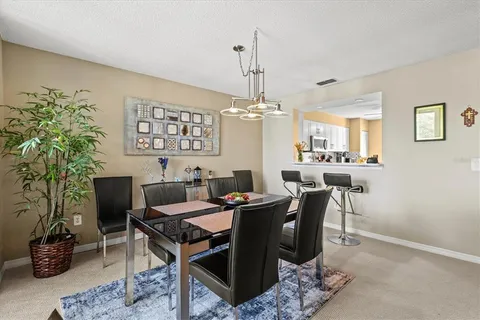 a view of a dining room with furniture window and outside view