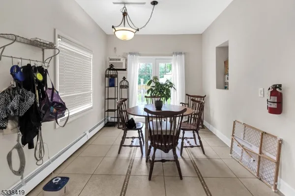 a dining room with furniture and window