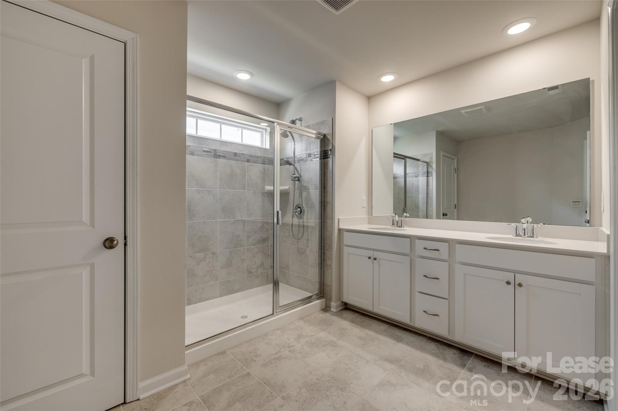 807 Gable Oak Lane Fort Mill, SC 29708 - Photo 20 of 39 a spacious bathroom with a shower sink and mirror