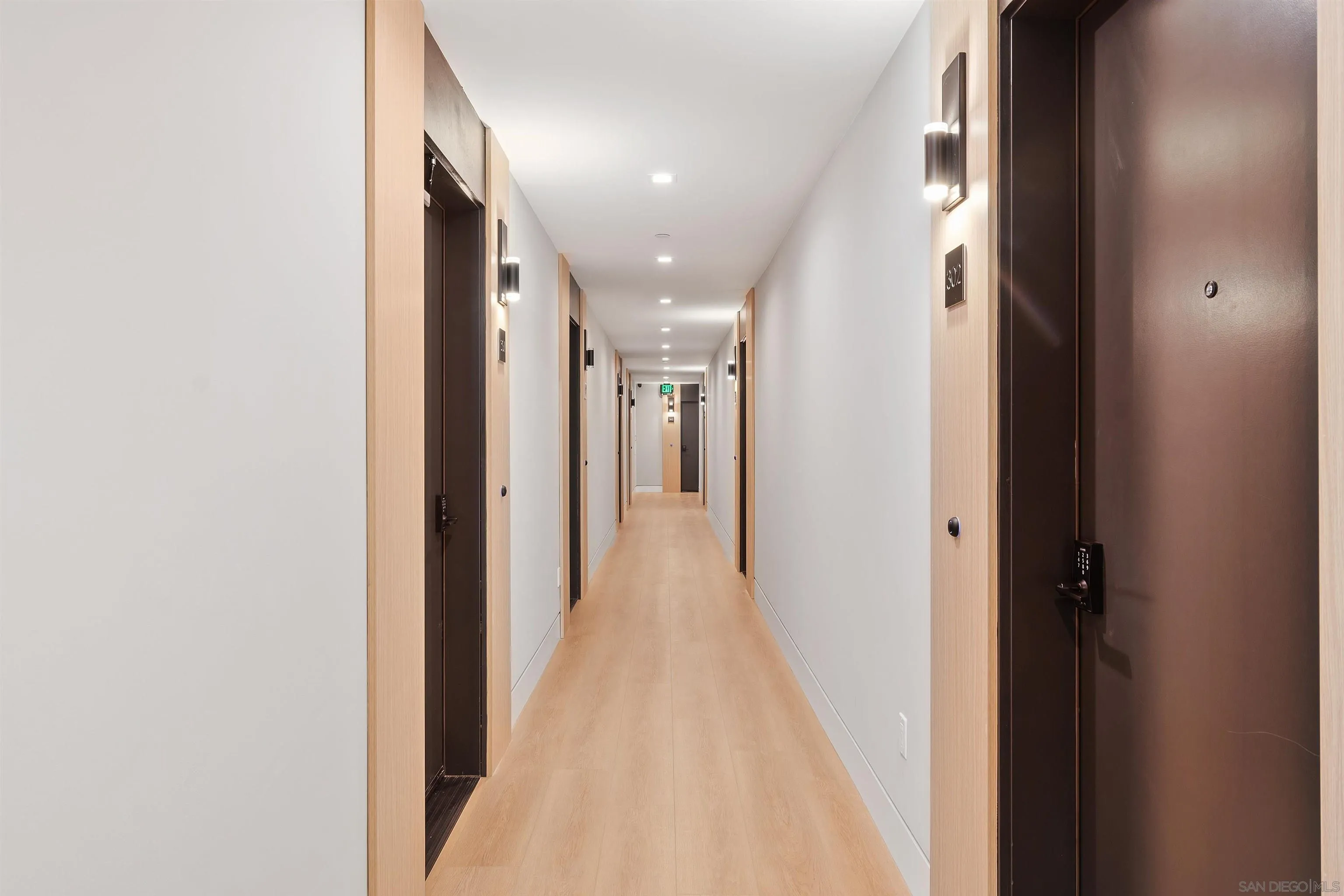 1111 Torrey Pines Road, Unit 203 La Jolla, CA 92037 - Photo 5 of 10 a view of a hallway with wooden floor