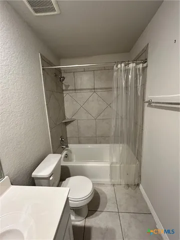 a bathroom with a toilet a sink and bathtub