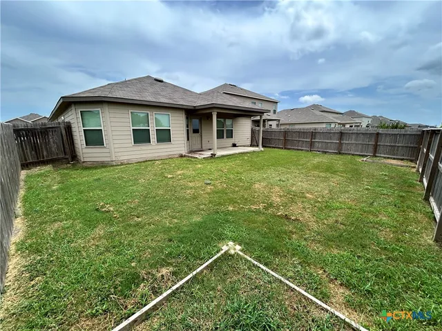 a view of a house with a backyard