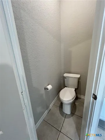 a white toilet sitting next to a sink