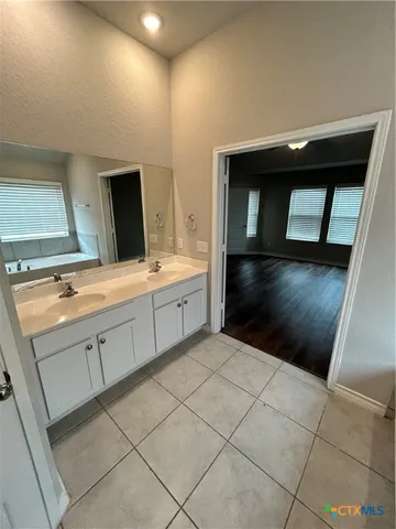 a kitchen with a sink and cabinets