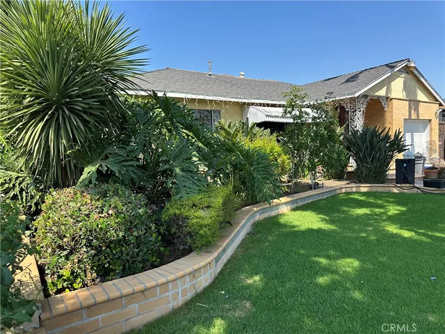 a view of a house with a yard and plants